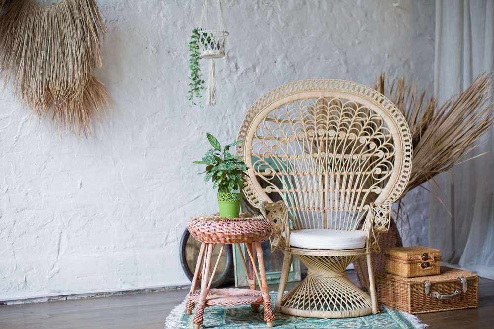 Rattan peacock chair in loft room with boho decorations